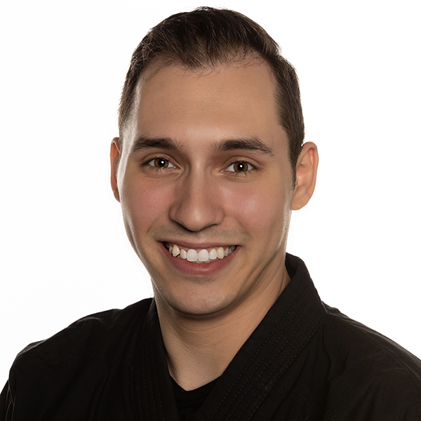 Benjamin Andersen smiling headshot from above the shoulders in front of white backdrop