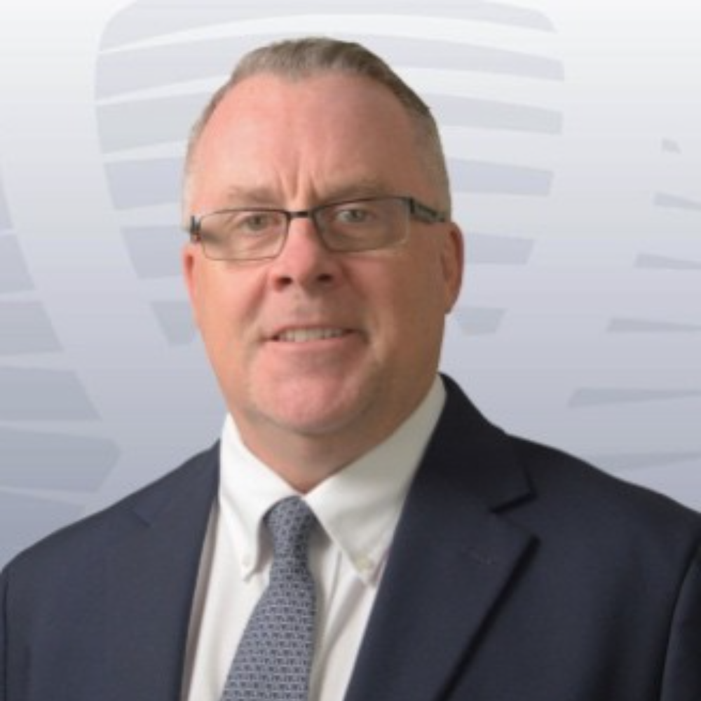 man with glasses wearing blue suit and tie